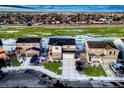 Aerial view of a neighborhood showcasing well-maintained homes, green spaces, and convenient street access in a serene setting at 1867 Homestead Dr, Fort Lupton, CO 80621