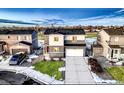 Stylish two-story home boasting neat landscaping, a two-car garage, and a welcoming front entrance, set in a residential area at 1867 Homestead Dr, Fort Lupton, CO 80621