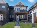 Inviting two-story home with a covered front porch and manicured lawn at 4571 Stuart St, Denver, CO 80212