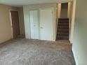 Spacious living room boasts plush carpeting, neutral walls, and convenient closet space, creating a cozy atmosphere at 8353 Gaylord St, Denver, CO 80229