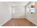 Bright bedroom with modern flooring and large windows providing natural light at 1713 Morgan Dr, Erie, CO 80516