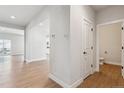 Hallway leading to a bathroom, stairs, and an open-concept layout at 1713 Morgan Dr, Erie, CO 80516