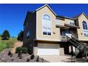 Charming townhouse featuring a stone-accented base, attached garage, and private entrance on a clear day at 1767 High Plains Ct, Superior, CO 80027