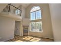 Bright living room featuring a fireplace, hardwood floors, and soaring windows for natural light at 1767 High Plains Ct, Superior, CO 80027