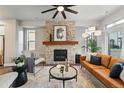 Stylish living room with stone fireplace, wood mantle, and comfortable seating at 15628 W Baker Ave, Lakewood, CO 80228