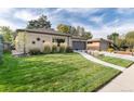 Attractive Ranch home with a landscaped yard and large grassy area at 6620 E Virginia Ave, Denver, CO 80224