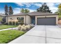 Brick ranch home with landscaped yard, attached garage, and updated exterior at 6620 E Virginia Ave, Denver, CO 80224