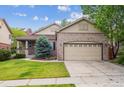 Beautiful brick home with a two-car garage and well-kept front yard at 21063 E Greenwood Pl, Aurora, CO 80013