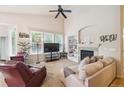 Bright living room with a fireplace, large windows, and vaulted ceilings at 21063 E Greenwood Pl, Aurora, CO 80013