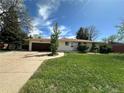Charming single-story home with a well-maintained lawn and attached garage at 1836 E Mineral Ave, Centennial, CO 80122