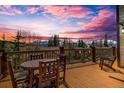 Outdoor deck with a wooden table and chairs offering scenic mountain views at 185 S Fuller Placer Rd, Breckenridge, CO 80424