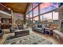 Spacious living room with vaulted ceilings, large windows, and comfortable seating at 185 S Fuller Placer Rd, Breckenridge, CO 80424