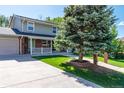Two-story home with brick accents and a long driveway leading to a convenient attached garage at 6150 Reed St, Arvada, CO 80003