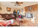 Inviting living room featuring a stone fireplace, wood floors and comfortable seating at 470 Mcdonnell St, Byers, CO 80103