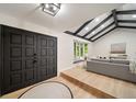 Modern entryway with black double doors and a view into the living room at 7910 E Bethany Pl, Denver, CO 80231