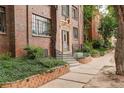 Brick building entrance with decorative stonework, tidy landscaping, and a secure entry at 1060 N Washington St # 1A, Denver, CO 80203