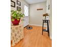 Cozy entryway with wood floors, a decorative rug, and a charming plant on a decorative table at 3266 S Wabash Ct, Denver, CO 80231