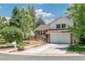 Charming two-story home with brick and siding, a landscaped yard, and an attached two-car garage at 6327 S Emporia Cir, Englewood, CO 80111