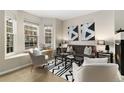 Charming living room with a fireplace, comfortable seating, and a sunny bay window with a view of the neighborhood at 3974 W 118Th Pl, Westminster, CO 80031
