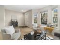 Bright living room with neutral colors, featuring a cozy seating area and a bay window offering natural light at 3974 W 118Th Pl, Westminster, CO 80031