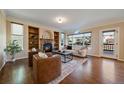 Bright living room boasts a fireplace, built-in shelves, large windows, and comfortable seating, perfect for relaxation at 10900 Parker Vista Rd, Parker, CO 80138