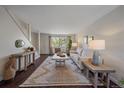 Open living room with contemporary decor, lots of natural light, and hardwood flooring at 3738 Miller Ct, Wheat Ridge, CO 80033
