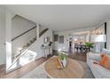 Spacious living room with an adjacent staircase and view of the dining area at 3738 Miller Ct, Wheat Ridge, CO 80033