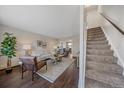 Bright living room featuring stylish decor and seamless transition to staircase at 3738 Miller Ct, Wheat Ridge, CO 80033