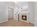 Bright living room with a fireplace and staircase at 8735 E 29Th Pl, Denver, CO 80238