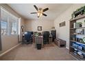 Spacious home office with built-in shelving, dual workstations, and a comfortable setting for productivity at 2028 Treetop Dr, Castle Rock, CO 80109