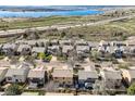 An aerial view showcases neighborhood homes near a lake and highway at 6853 W Rockland Pl, Littleton, CO 80128