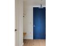 Entryway featuring a blue door and a built-in bench with shelf at 1750 Wewatta St # 1536, Denver, CO 80202