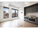 A kitchen shows stainless steel appliances and hardwood floors at 1750 Wewatta St # 1536, Denver, CO 80202