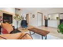 Cozy living room with a fireplace, wood floors and staircase at 1927 Pine St # B, Boulder, CO 80302