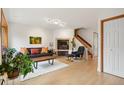 Comfortable living room with a fireplace, wood floors and staircase at 1927 Pine St # B, Boulder, CO 80302