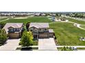 Beautiful aerial view of a neighborhood home, near a large community park and playground at 15352 E 117Th Ave, Commerce City, CO 80022