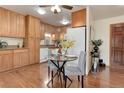 Cozy kitchen and dining area with wood cabinets and modern appliances at 625 S Alton Way # 10D, Denver, CO 80247