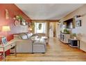 Cozy living room featuring hardwood floors and comfortable leather sectional sofa at 1425 S Newport St, Denver, CO 80224