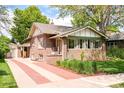 Beautiful home showcasing a brick driveway, manicured lawn, and classic architectural details at 1767 S Sherman St, Denver, CO 80210