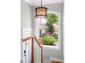 Bright stairway featuring a large window offering views of the well-maintained backyard at 1767 S Sherman St, Denver, CO 80210