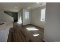 Bright living room with wood floors and natural light from windows and sliding glass door at 22813 E Tufts Ave # B, Aurora, CO 80015