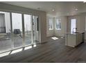 Open living space with access to outdoor patio through sliding glass doors, modern finishes at 22813 E Tufts Ave # B, Aurora, CO 80015