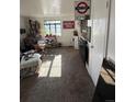 Comfortable living area with natural light, carpeted floors, and a view into the kitchen at 1265 Yates St, Denver, CO 80204