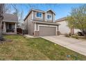 Charming two-story home with a well-maintained lawn, attached two-car garage, and lush green yard at 6774 St Vrain Ranch Blvd, Firestone, CO 80504