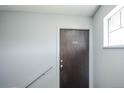 Condo apartment door with a visible unit number and secured with a lock at 3855 S Monaco St # 208, Denver, CO 80237