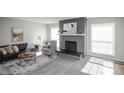 Inviting living room with decorative fireplace, ample natural light, and stylish furnishings at 3855 S Monaco St # 208, Denver, CO 80237