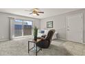 Bright living room featuring sliding glass doors to the patio, plush carpet, and neutral decor creates a relaxing ambiance at 2246 N Coronado Pkwy # A, Denver, CO 80229