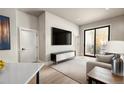 Bright living room featuring a sliding glass door to a balcony and modern furnishings at 1643 Boulder St # 205, Denver, CO 80211