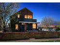Charming home at twilight, with warm interior lights creating a cozy ambiance and inviting feel at 190 W Archer Pl, Denver, CO 80223