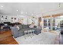 Open living room with hardwood floors, a comfortable gray sofa, and plenty of natural light at 190 W Archer Pl, Denver, CO 80223
